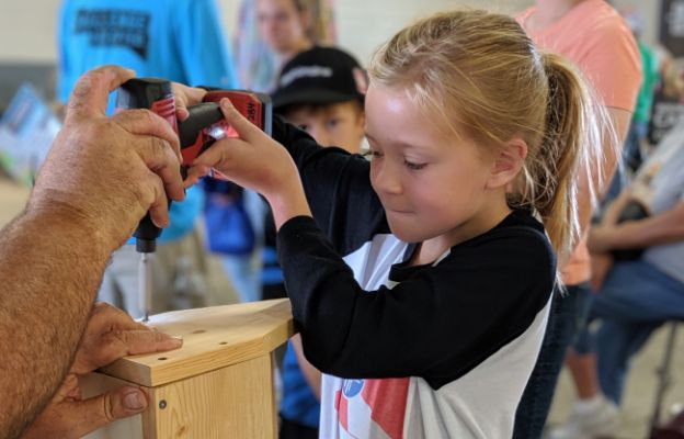 kid learning how to drill at the kansas state fair in hutchinson