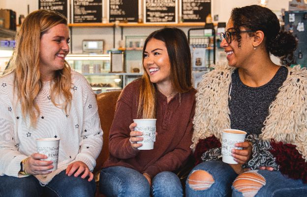 three girls enjoying coffee at reverie roasters in downtown wichita, kansas talking about the holiday gift guide