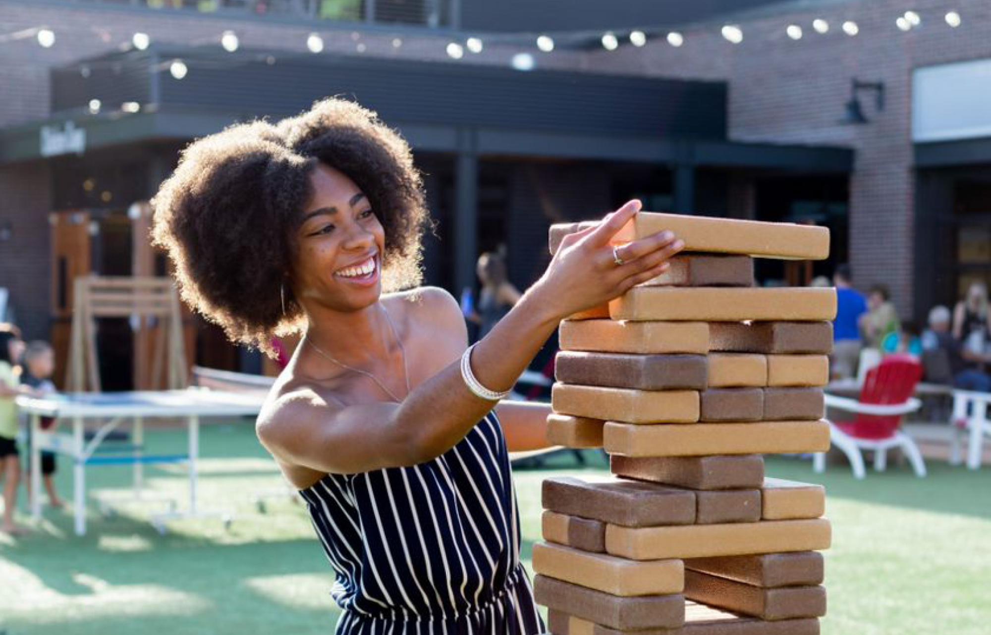 Wichita koch industries intern playing jenga at chicken n pickle in kansas