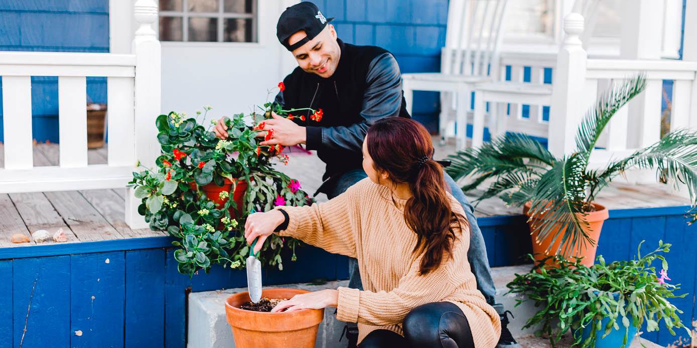 couple planting flowers at home in college hill, wichita kansas